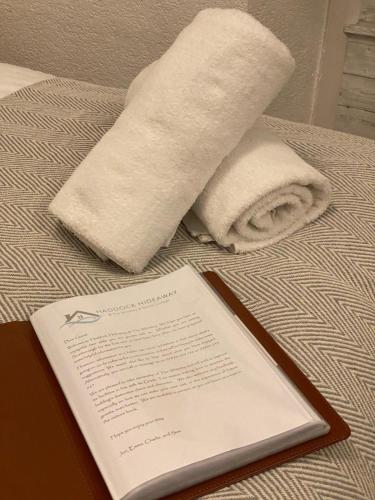 a towel and a paper towel on a bed at Haddock Hideaway at The Whiteley in Scarborough
