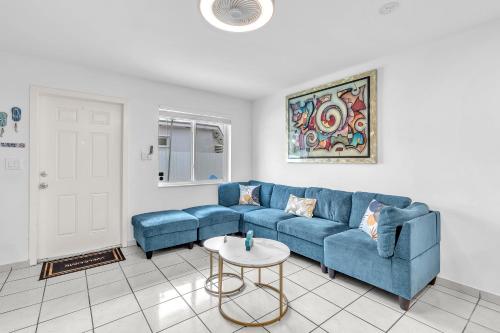 a living room with a blue couch and a table at Relaxing Miami Retreat with Canal View and a Central Location in Miami