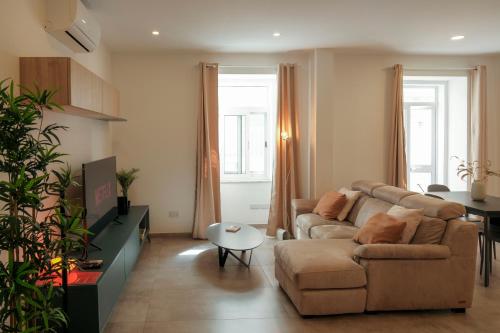 a living room with a couch and a table at Tan-Nanna by Shmoo, Sliema Ferries in Sliema