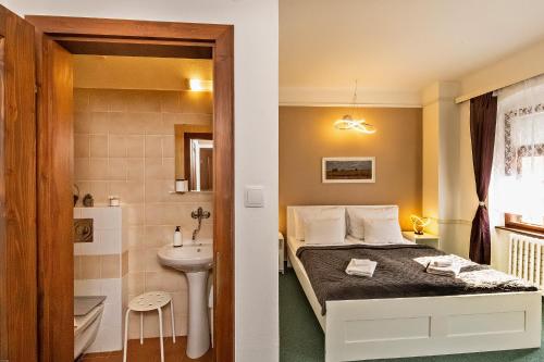 a small bedroom with a bed and a sink at Penzion Landauer in Český Krumlov
