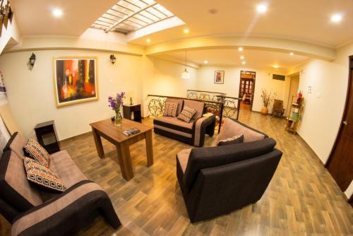 a living room with two couches and a table at Hotel Golden Killa in Huaraz