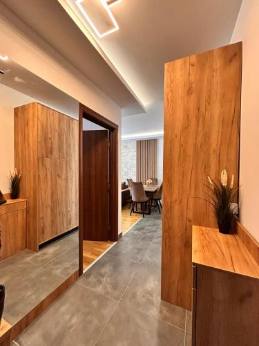 a hallway with wooden panels and a dining room at Green Peak in Divčibare