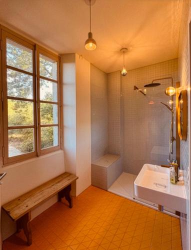 a bathroom with a tub and a sink and a shower at Le Couvent in Lunac