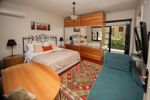 a bedroom with a bed and a table and a couch at Villa Cecilia in Göcek