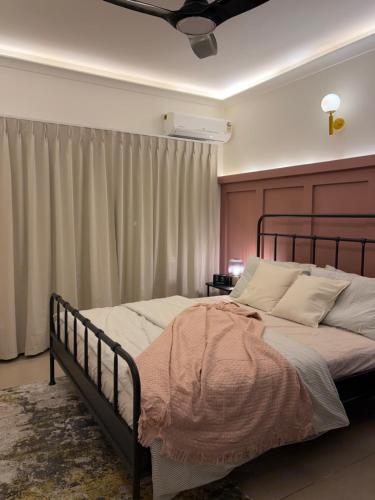 a bedroom with a large bed with a wooden headboard at Casa Lobo in Mapusa
