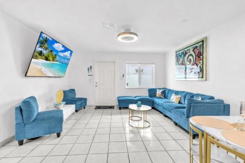 a living room with blue couches and a table at Relaxing Miami Retreat with Canal View and a Central Location in Miami