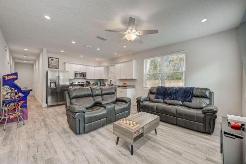 a living room with two leather couches and a kitchen at 1mi to Downtown! 3BR6BedsScreenroom,Deck,Firepit in St. Augustine