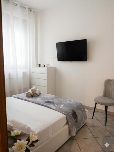 a bedroom with a bed and a television on a wall at appartamento a careggi casa diamante in Florence