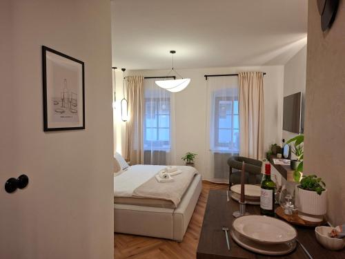 a living room with a bed and a dining room table at Old Town Living Studio in Český Krumlov