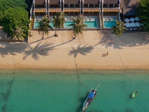 an overhead view of a beach with two boats in the water at Pano Samui Beachfront Villas in Nathon Bay