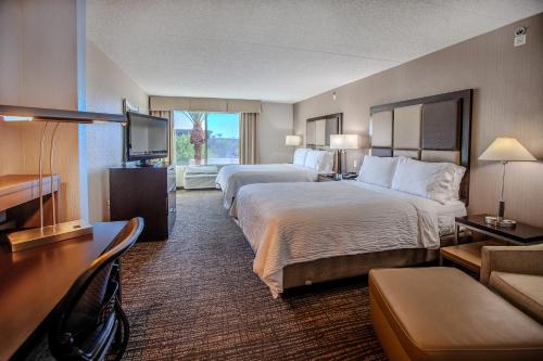 a hotel room with two beds and a flat screen tv at Holiday Inn Scottsdale North- Airpark by IHG in Scottsdale