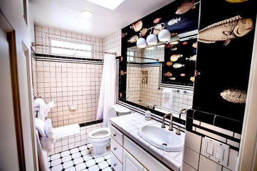 a bathroom with a sink and a toilet and a mirror at Beachbound Bliss in Del Mar in San Diego