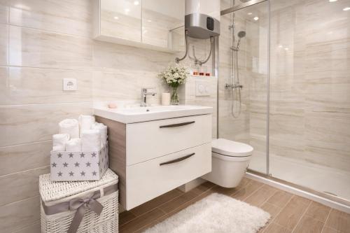 a bathroom with a sink and a toilet and a shower at Villa Verde Royal in Kaštela