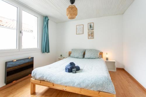 a bedroom with a bed with a teddy bear on it at Maison Centre ville in La Roche-sur-Yon