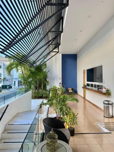 an open lobby with a staircase with plants at Anah Suites by Las Flores Vacation Rentals in Playa del Carmen
