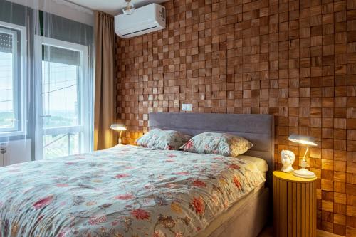 a bedroom with a bed and a brick wall at OPG Kuzmanović in Goljak