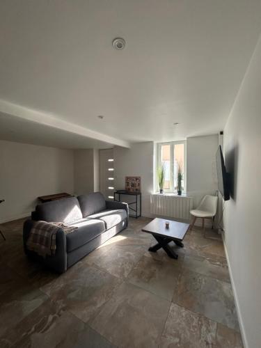 a living room with a couch and a table at La Petite Maison in Toutlemonde