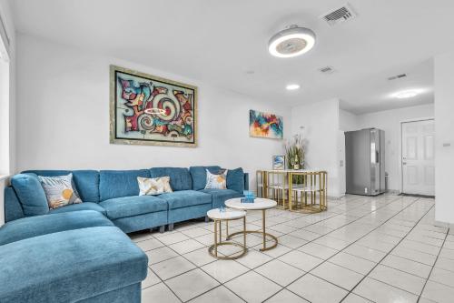a living room with a blue couch and a table at Relaxing Miami Retreat with Canal View and a Central Location in Miami