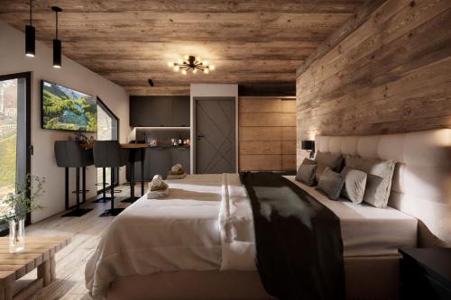 a bedroom with a large bed and wooden walls at ELAFON Lodge in Kolašin