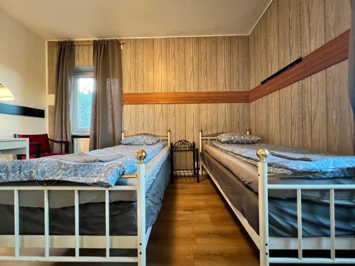 a bedroom with two beds and a table at Grums self-service house in Grums