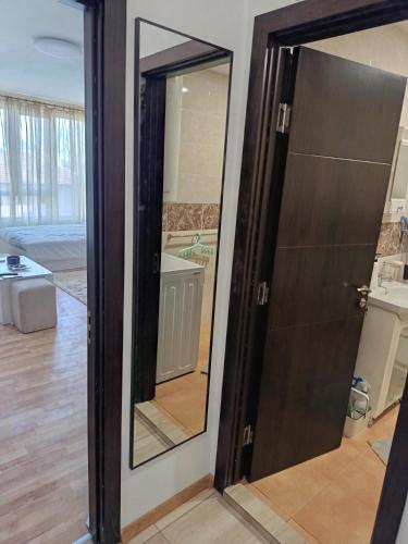 a glass door with a mirror in a room at Дунав апарт Danube apart in Vidin