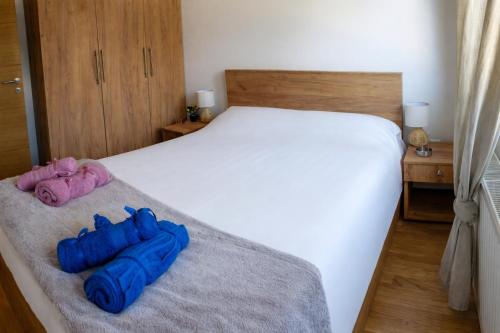 a bedroom with a bed with two blue bags on it at Mali Raj in Zlatibor
