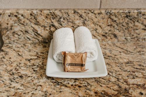 a white plate with towels and a box of chocolate at La Pinta Hotel in Ensenada