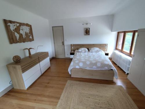a bedroom with a bed and a sink in it at La Ronce maison d hote - piscine SPA in Rouvres