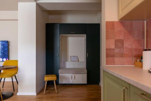 a kitchen with a refrigerator and a table at Habitat Suites II in Craiova