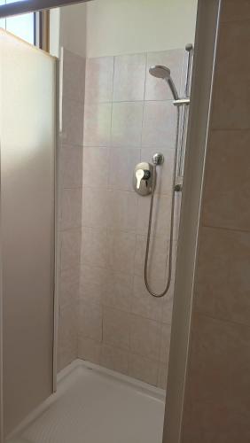 a bathroom with a shower with a glass door at Casa Nonno Maiti in Scardovari