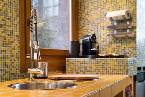 a kitchen counter with a sink and a mirror at Authentic Lake Como Home near Bellagio in Limonta