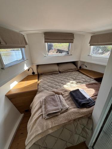a small bed in the middle of a small room at Unique 2 Bed Waterside Retreat Pet Friendly in Upton upon Severn