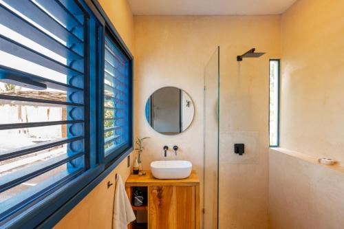 a bathroom with a sink and a mirror at Casa Omero Seaview. in El Cuyo