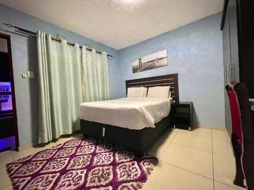 a bedroom with a bed in a blue room at Bluenova guesthouse in Dundee