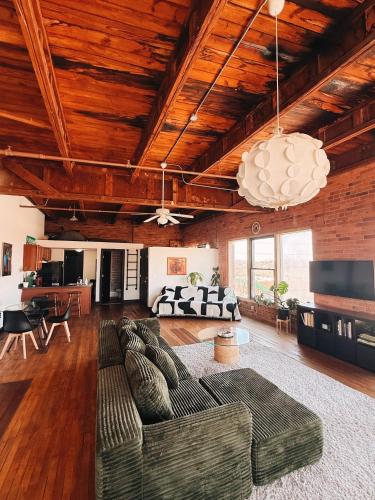 a living room with two couches and a table at 420 Friendly SKYLINE view Downtown Loft FREE Parking in Detroit
