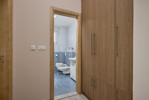 a bathroom with a toilet and a mirror and a door at Libera Vista by MN Property in Kotor