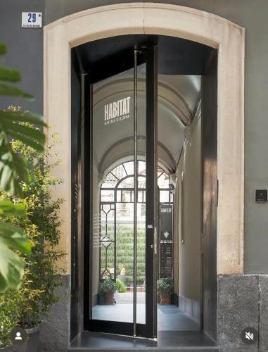 an entrance to a building with a glass door at Habitat Boutique Hotel in Catania