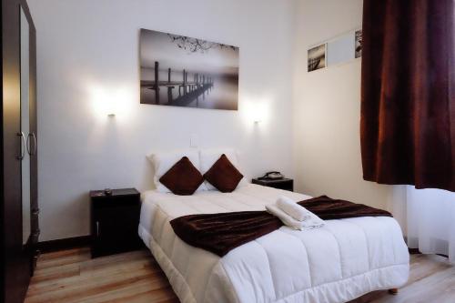Postel nebo postele na pokoji v ubytování Hôtel Pedussaut