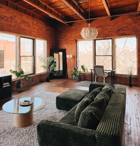 a living room with a couch and a table at 420 Friendly SKYLINE view Downtown Loft FREE Parking in Detroit