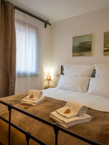 a bedroom with a large bed with towels on it at Cjase san Pieri in Cividale del Friuli