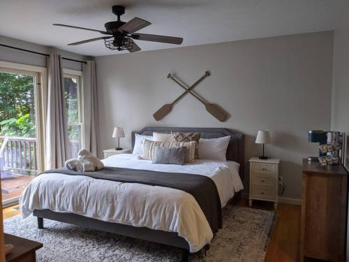 a bedroom with a large bed with a ceiling fan at Hidden Shores in Big Sandy