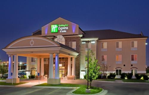 a hotel with a sign on the front of a building at Holiday Inn Express Hotel & Suites Wichita Airport by IHG in Wichita