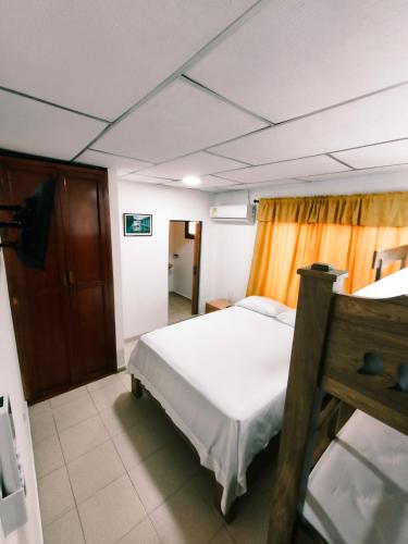 a bedroom with a white bed in a room at Casa Aranza in Cartagena de Indias