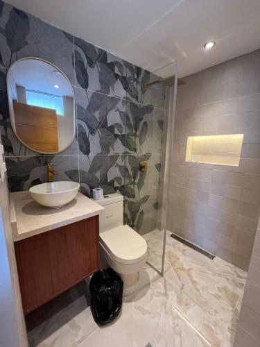 a bathroom with a toilet and a sink and a mirror at Casa del Inka Perú in Lima
