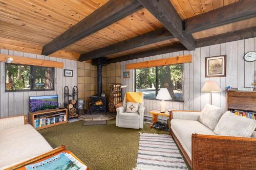 a living room with a couch and a table at Mirthwood Den in Tahoma