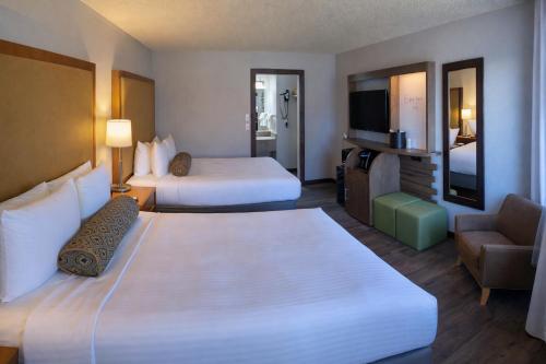 a hotel room with two beds and a television at The Dalles Inn in The Dalles