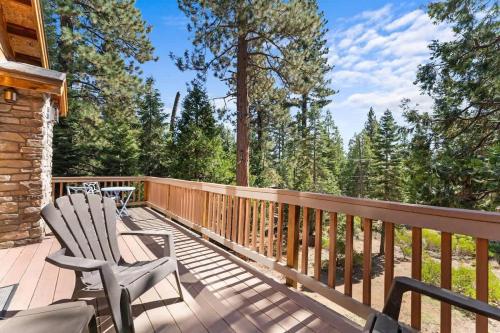 a deck with two chairs sitting on it at The Wildwood Lodge in Tahoe Vista