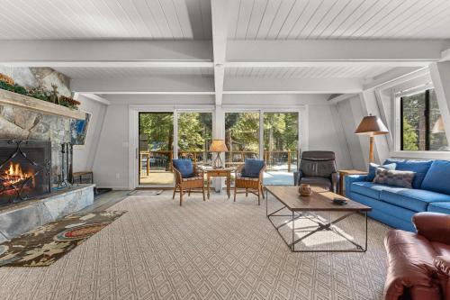 a living room with a blue couch and a fireplace at Agate Bay Chalet in Carnelian Bay