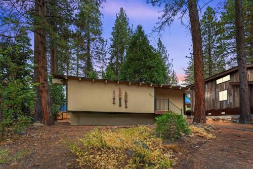 a building in the middle of a forest at Dolly Varden Cottage in Kings Beach