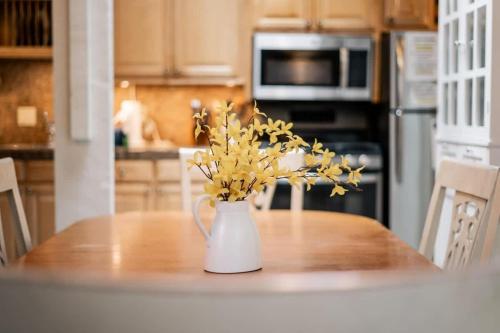 a vase with yellow flowers on a table in a kitchen at Dolly Varden Cottage in Kings Beach
